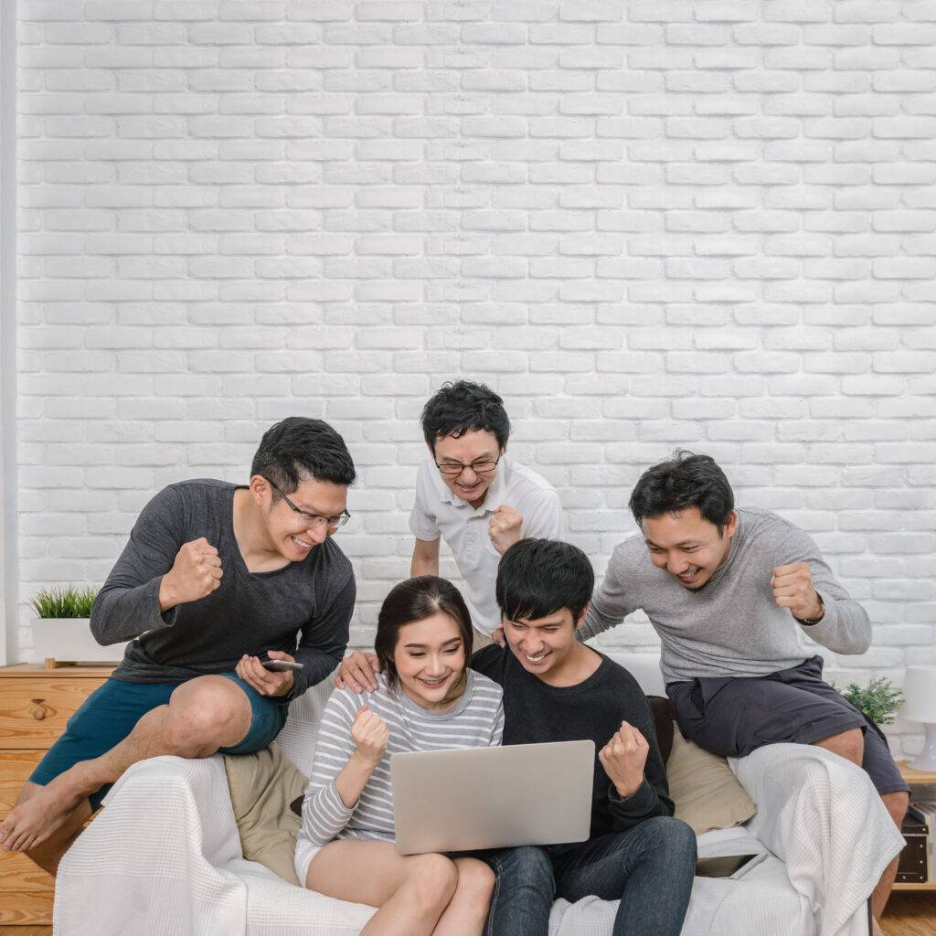 friends-gathered-around-laptop-cheering-and-celebr-2026-01-05-06-10-35-utc